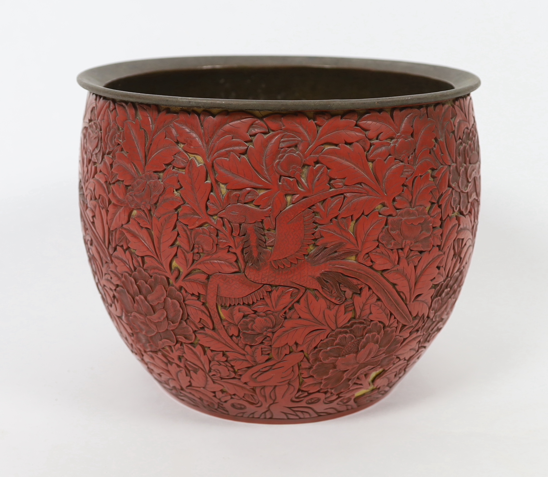 A large Chinese cinnabar lacquer ‘pheasant and peony’ jardiniere, 19th century, losses and numerous loose sections